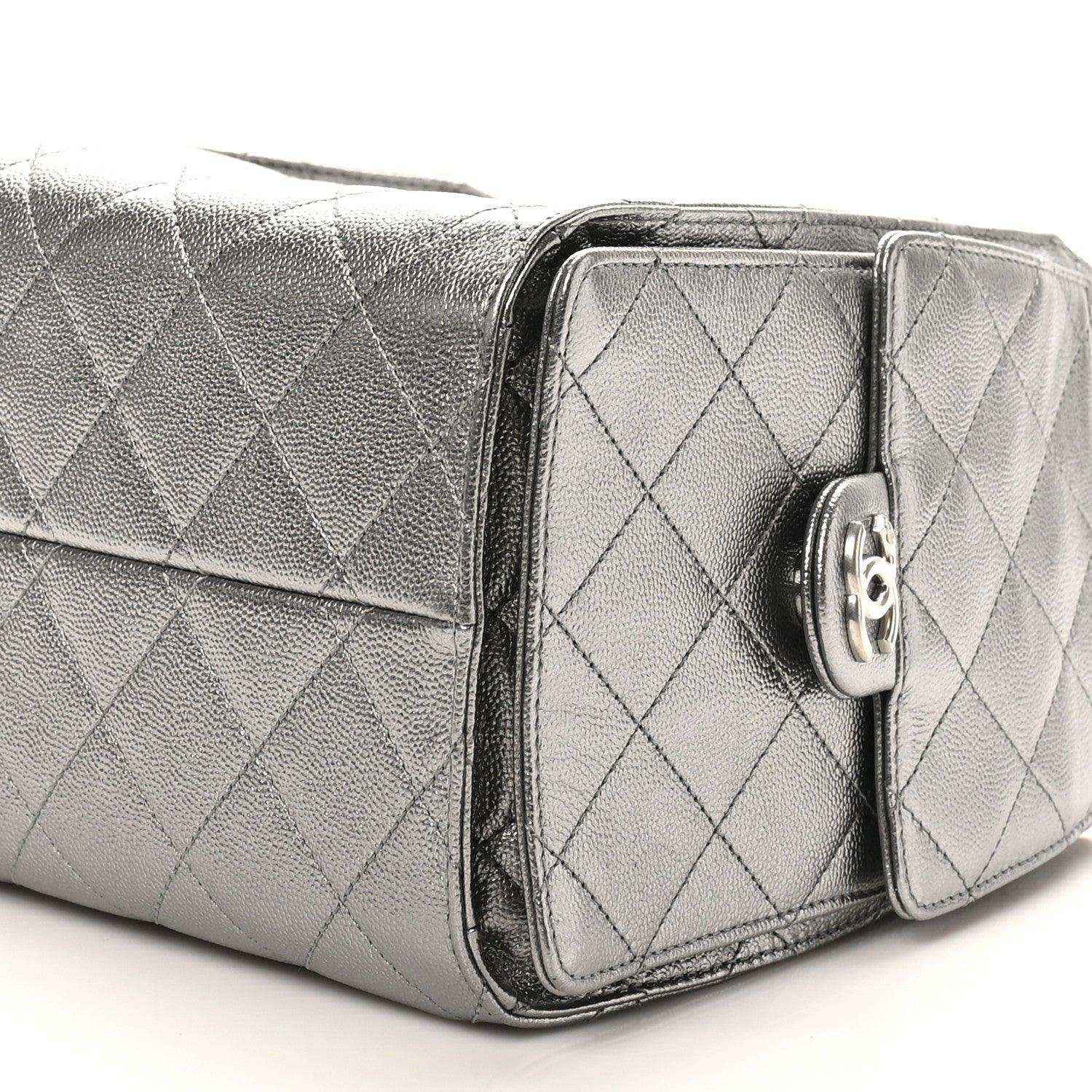 Chanel metallic quilted handbag side view with front pocket flap and turn-lock