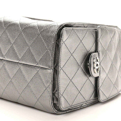 Chanel metallic quilted handbag side view with front pocket flap and turn-lock