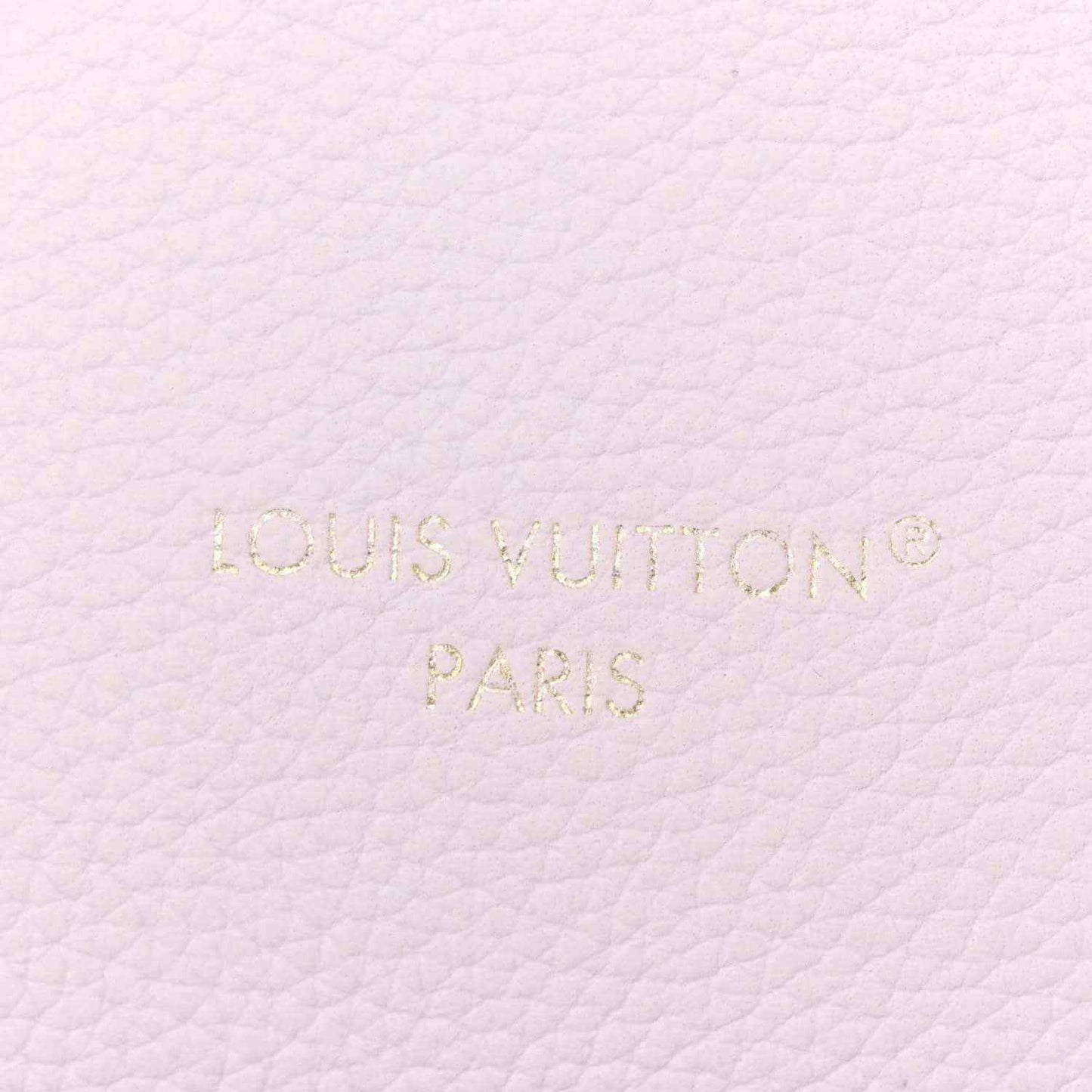 Embossed “Louis Vuitton Paris” on pale lilac leather surface