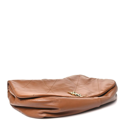 Tan quilted leather bag with folded top edge and gold monogram clasp