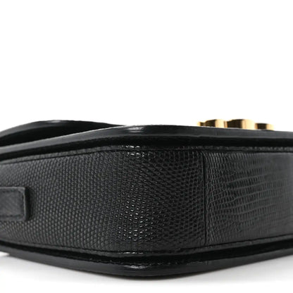Black lizard-embossed side panel of flap shoulder bag