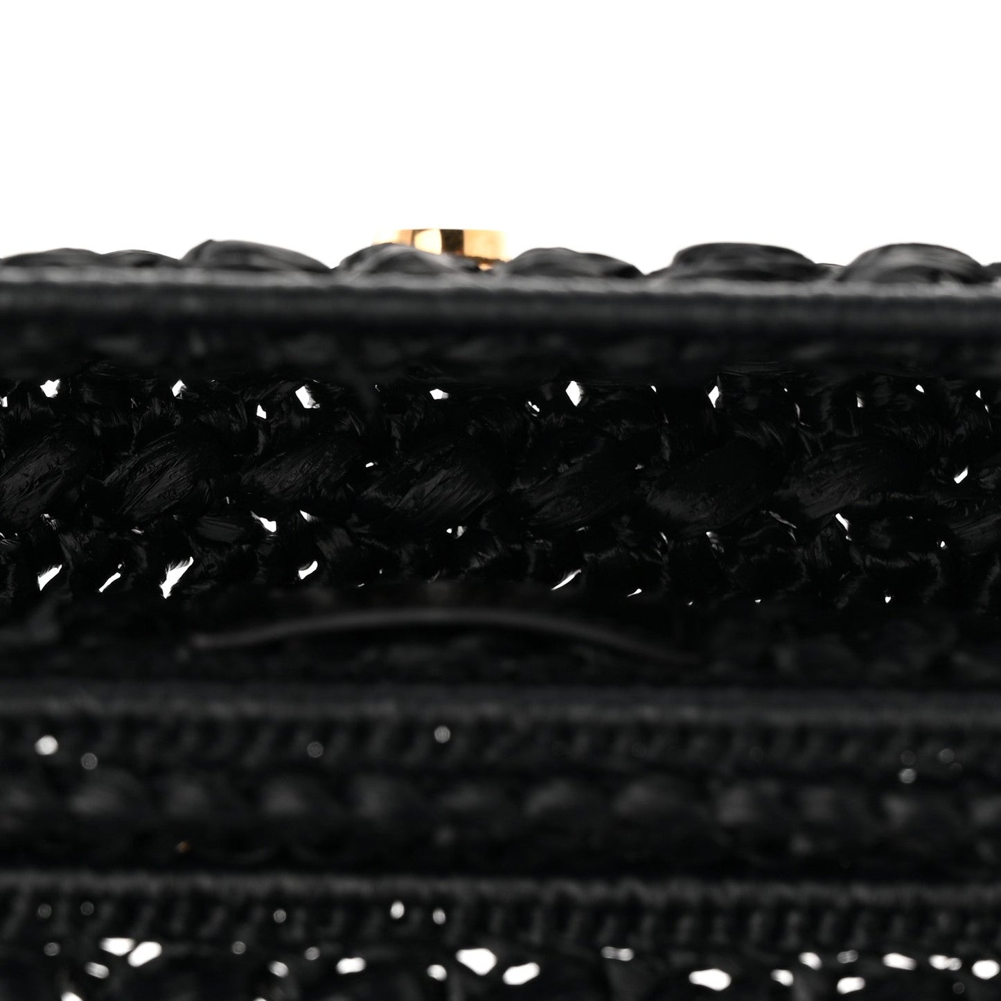Close-up of black woven raffia-effect fabric trim along the bag edge
