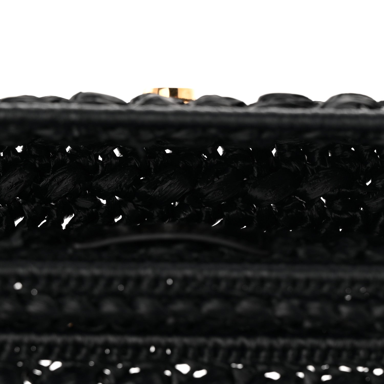 Close-up of black woven raffia-effect fabric trim along the bag edge