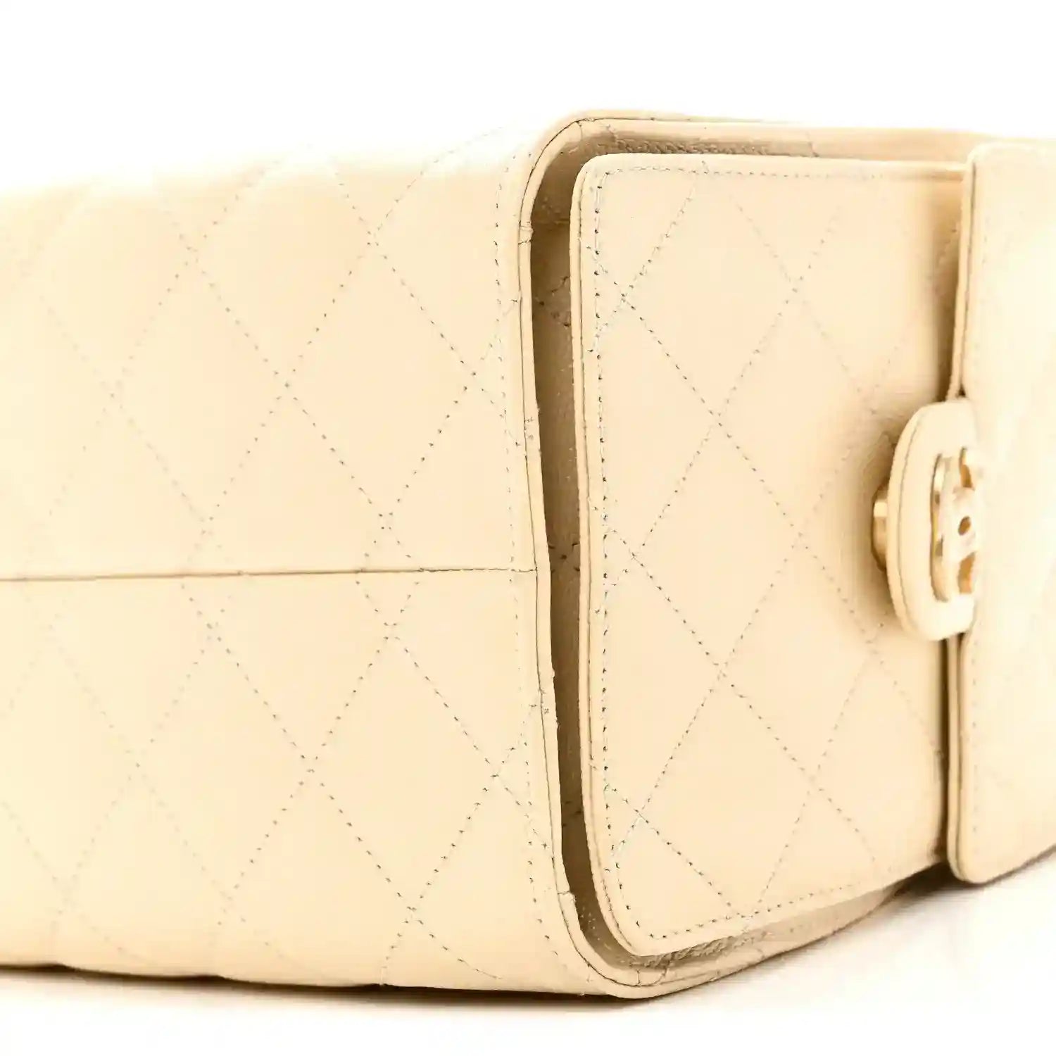 Light beige quilted handbag with front flap and gold-tone clasp closure