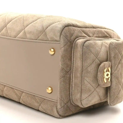Chanel dark grey quilted suede bowling bag close-up of gold snap panel