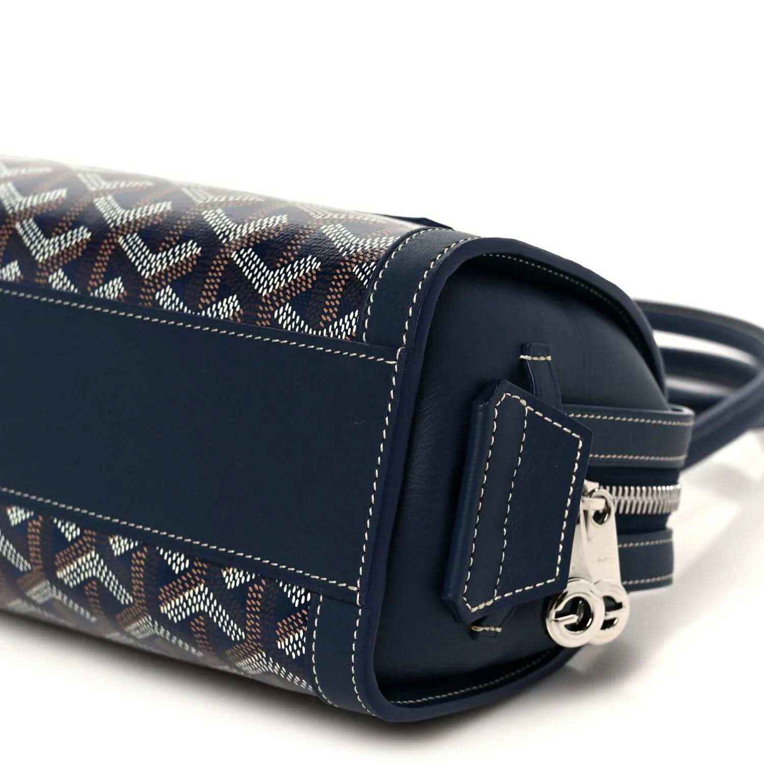 Side view of Goyardine Bonbonniere bag with adjustable strap and metal clasp