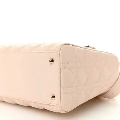 Pink quilted lambskin Lady Dior bag with gold-tone studs and top zip.