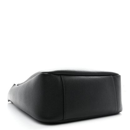 Black leather soft hobo bag close-up, showing rounded shape and smooth grain