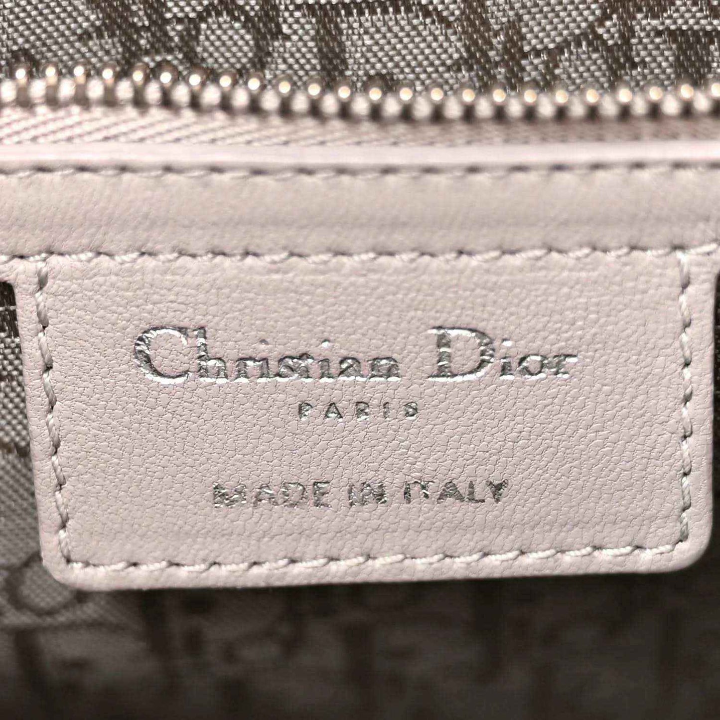 Designer label on grey quilted leather Lady Dior handbag front panel