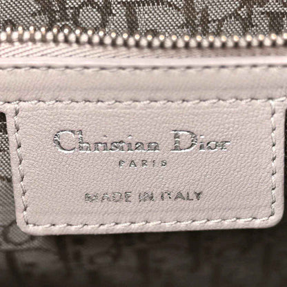 Designer label on grey quilted leather Lady Dior handbag front panel