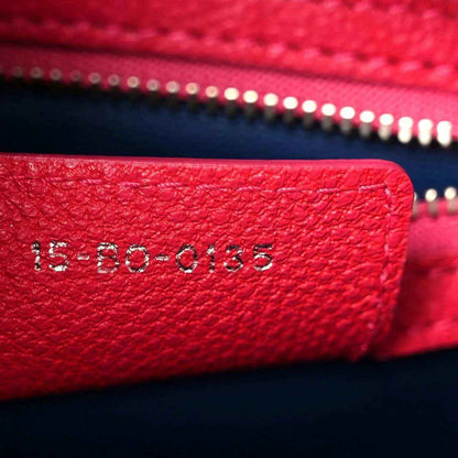 Red leather serial code stamped on handbag