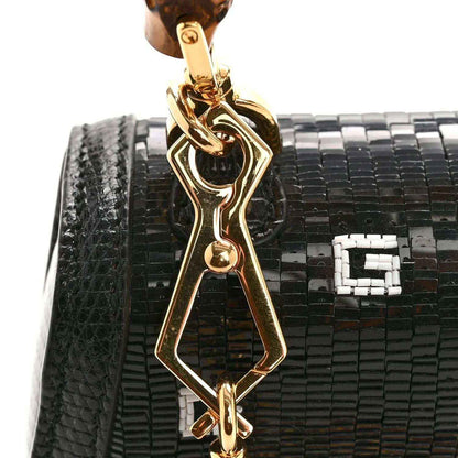 Gucci mini top handle bag with black lizard-embossed texture and gold bamboo clasp