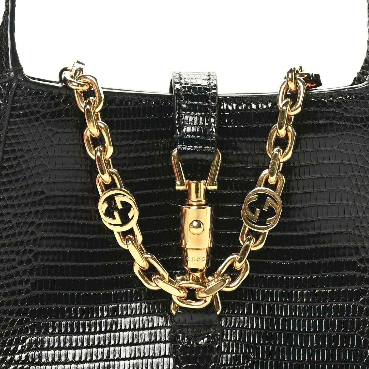 Black lizard mini Jackie handbag with gold-tone chain links and front clasp centerpiece.