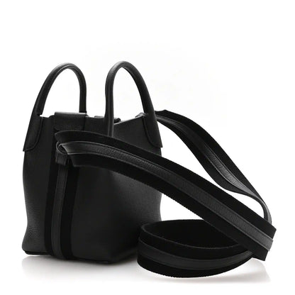 Black grained leather micro bale bag with two top handles and long crossbody strap