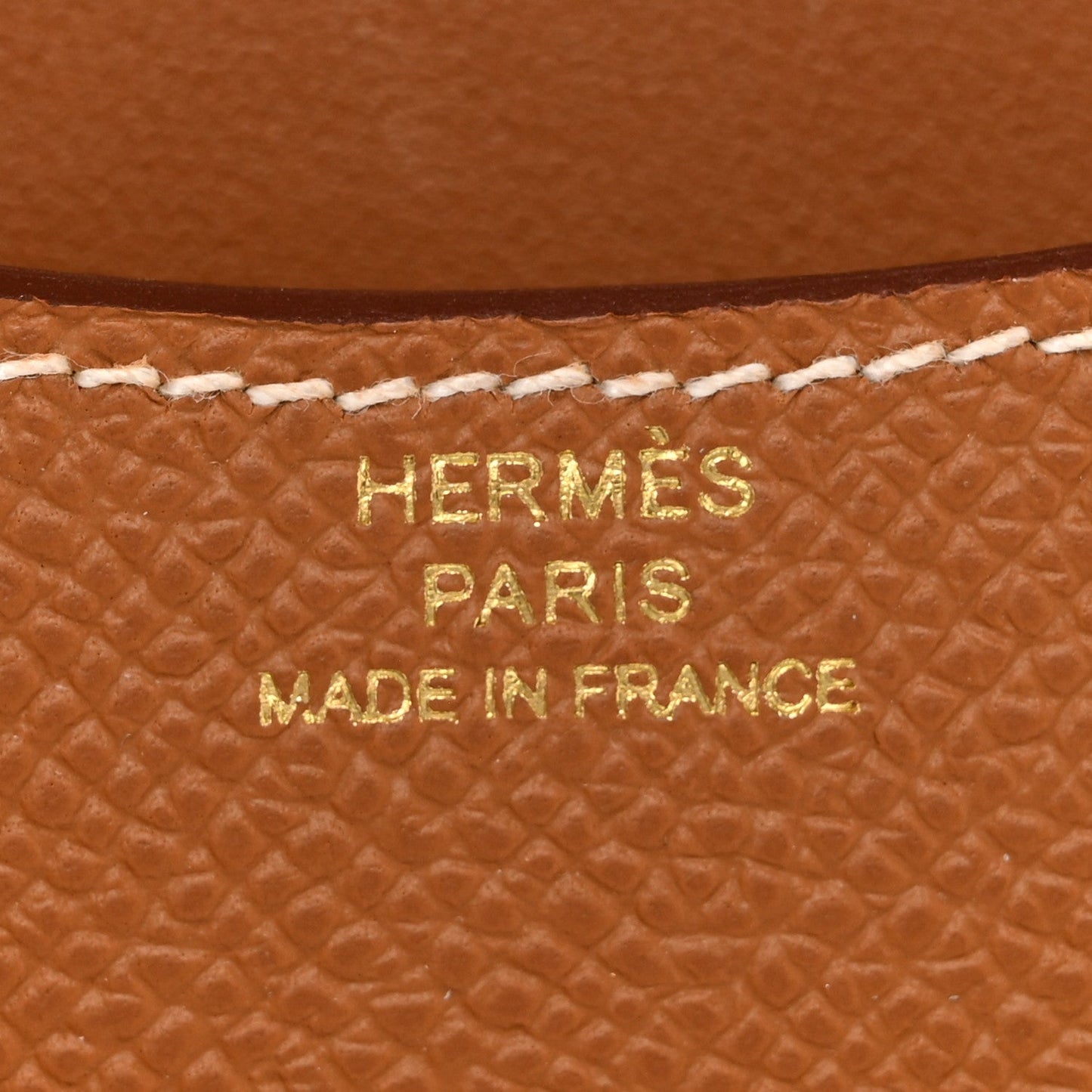 Hermes Paris made in France stamped on brown textured leather wallet.
