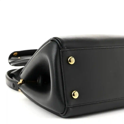 Black Small Madrid bag side panel with gold-tone studs and structured top edge.