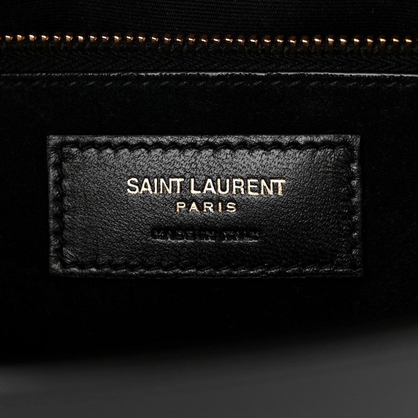 Saint Laurent black leather interior label reading "SAINT LAURENT PARIS"