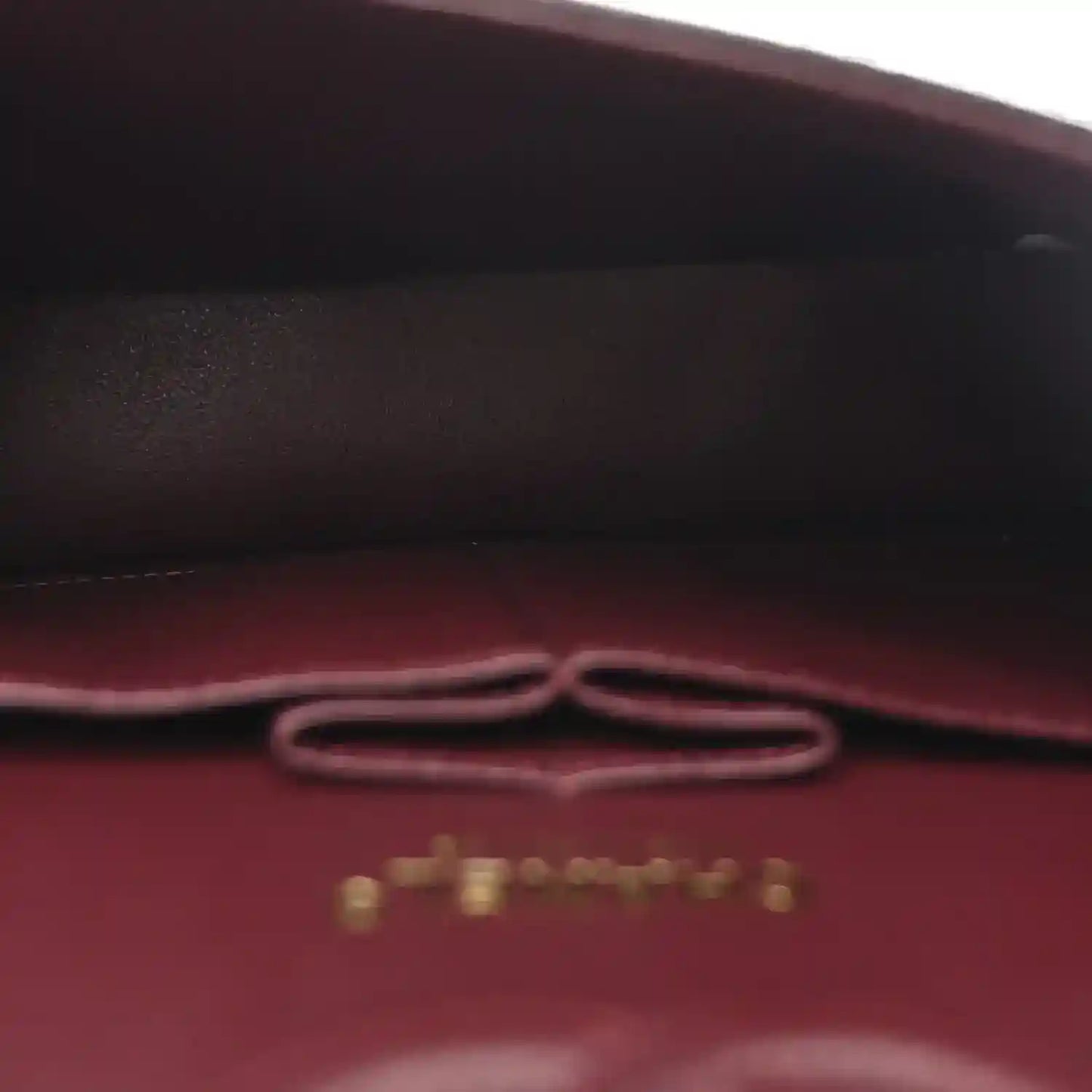 Chanel small bag interior with burgundy lining and gold chain clasp hardware