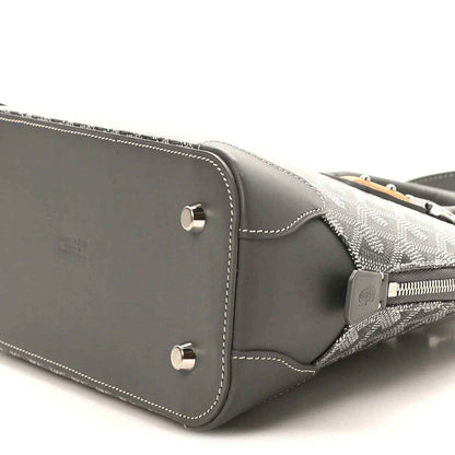 Grey handbag side panel with silver studs and contrast white stitching detail.