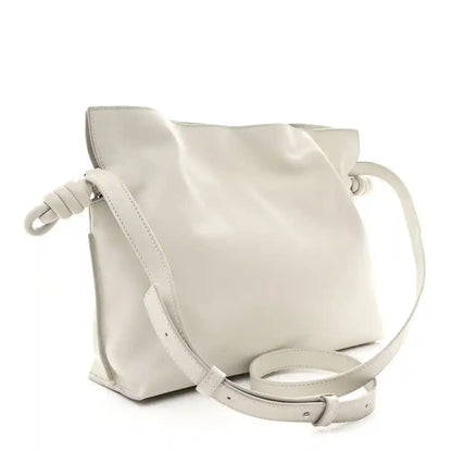 Knot clutch with pale grey leather finish and adjustable crossbody strap