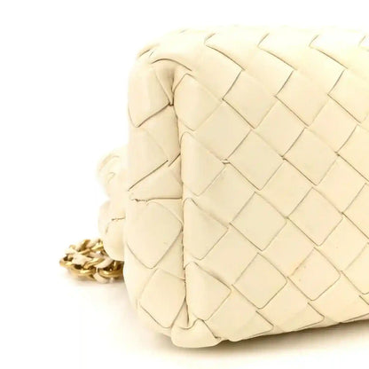 White leather intrecciato clutch side view with gold-tone chain