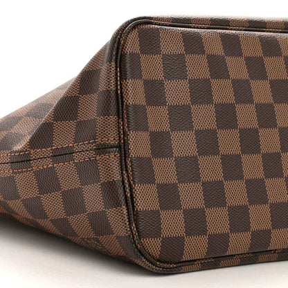 Damier Ebene tote bag side with brown check canvas, leather piping, and inner pocket seam