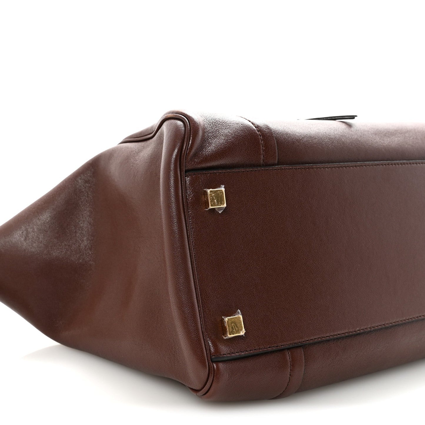 Dark brown lambskin handbag corner with gold-tone square stud and reinforced seam