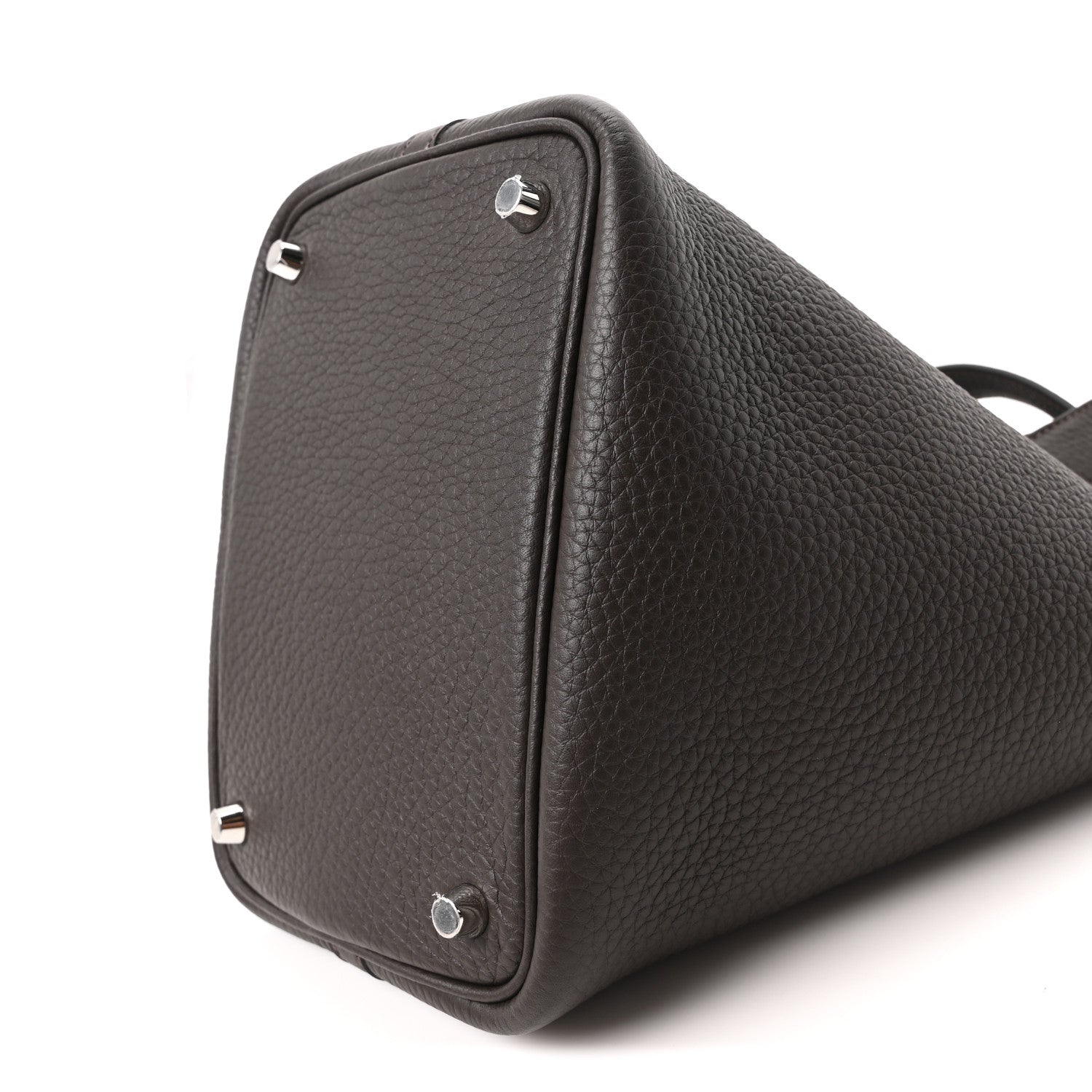 Dark brown leather tote bag side view with metal corner rings and textured finish