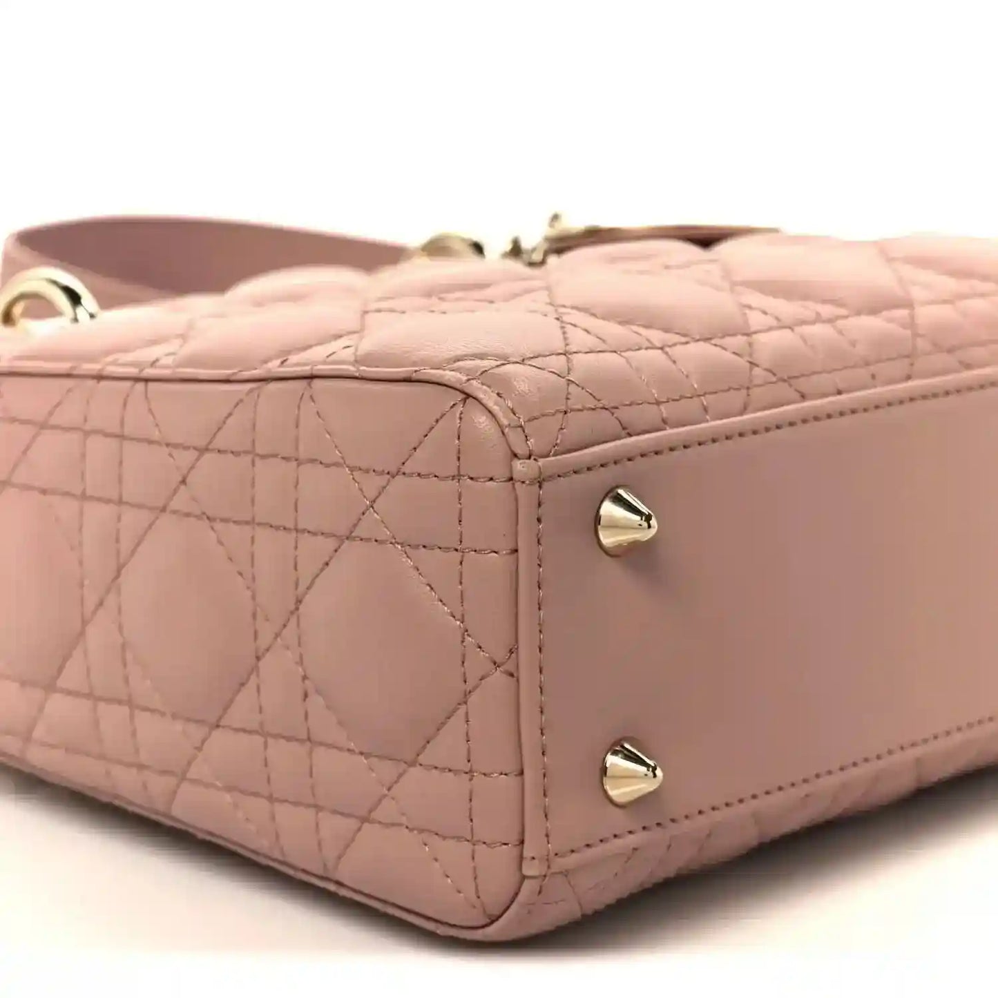 Quilted side panel of blush pink Lady Dior bag with corner stitching and hardware