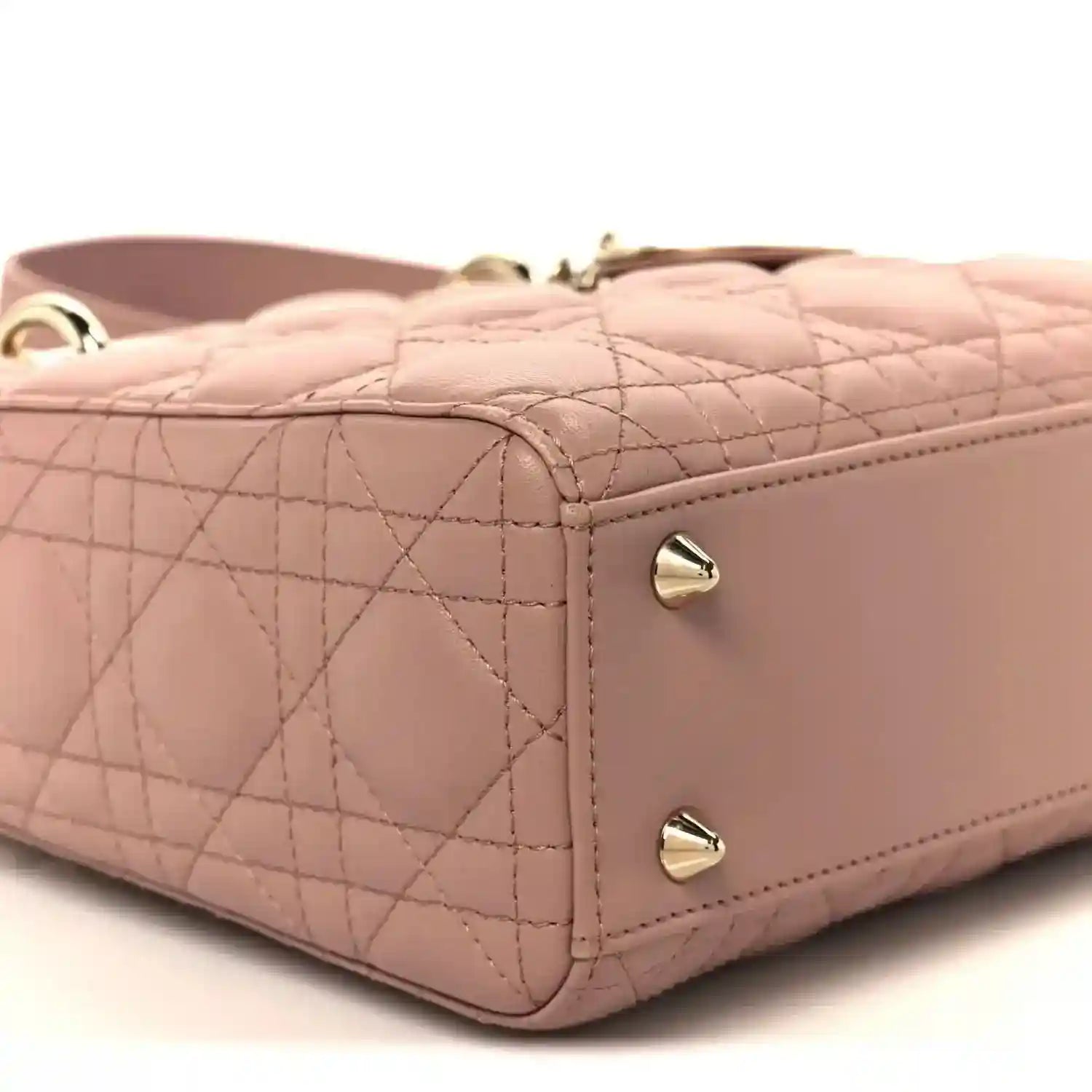 Quilted side panel of blush pink Lady Dior bag with corner stitching and hardware