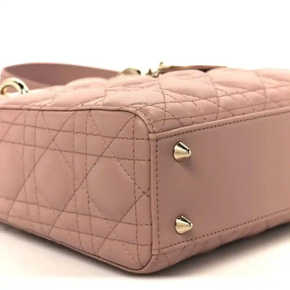 Quilted side panel of blush pink Lady Dior bag with corner stitching and hardware