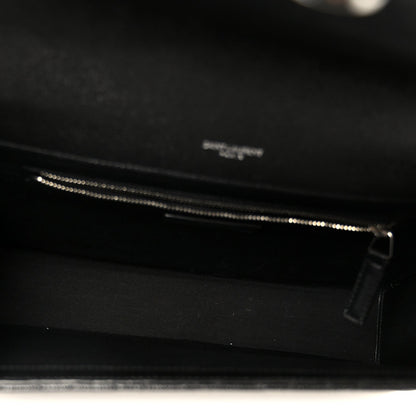 Black satchel interior with zipper track and zipper pull visible at opening