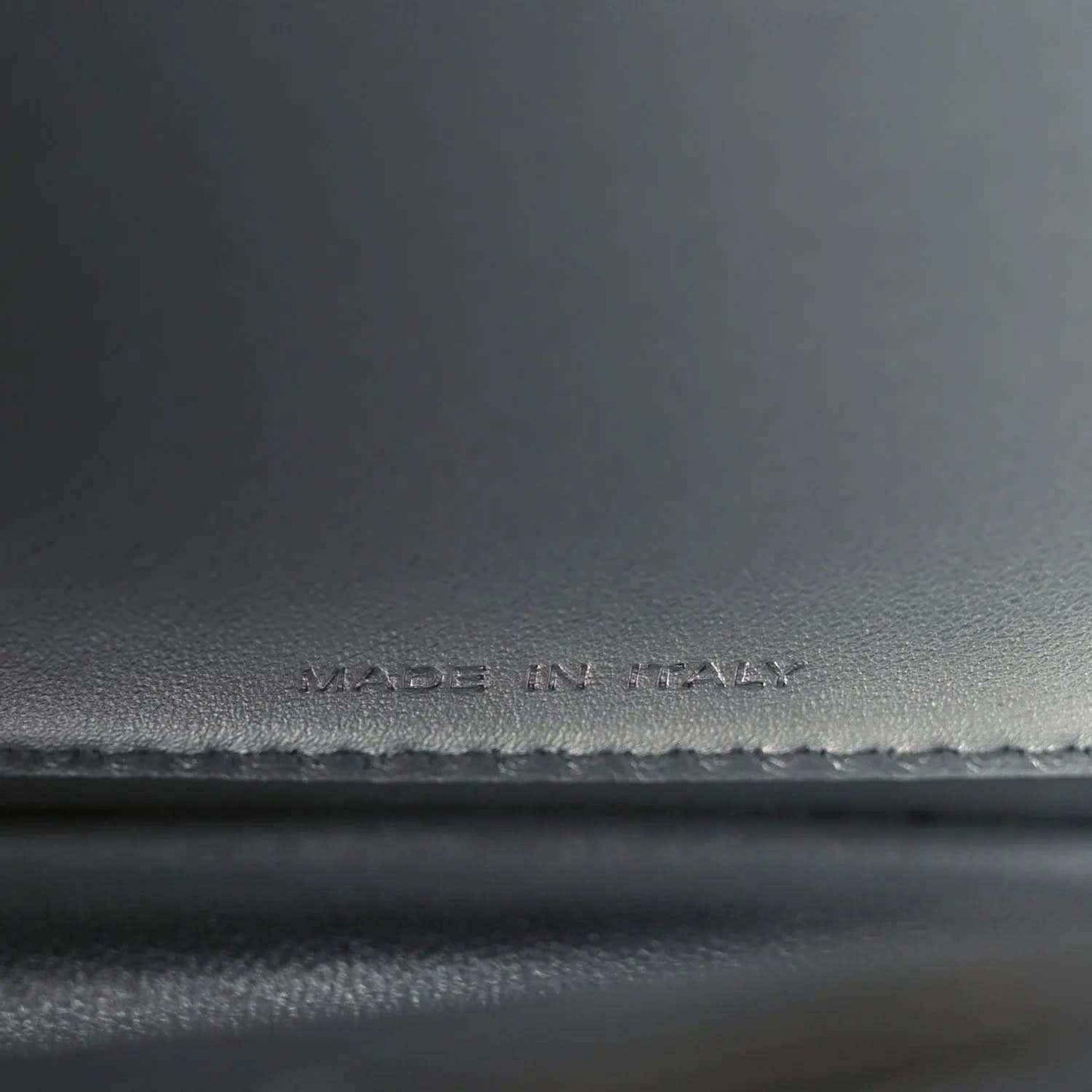 Made in Italy stamp on dark leather satchel interior