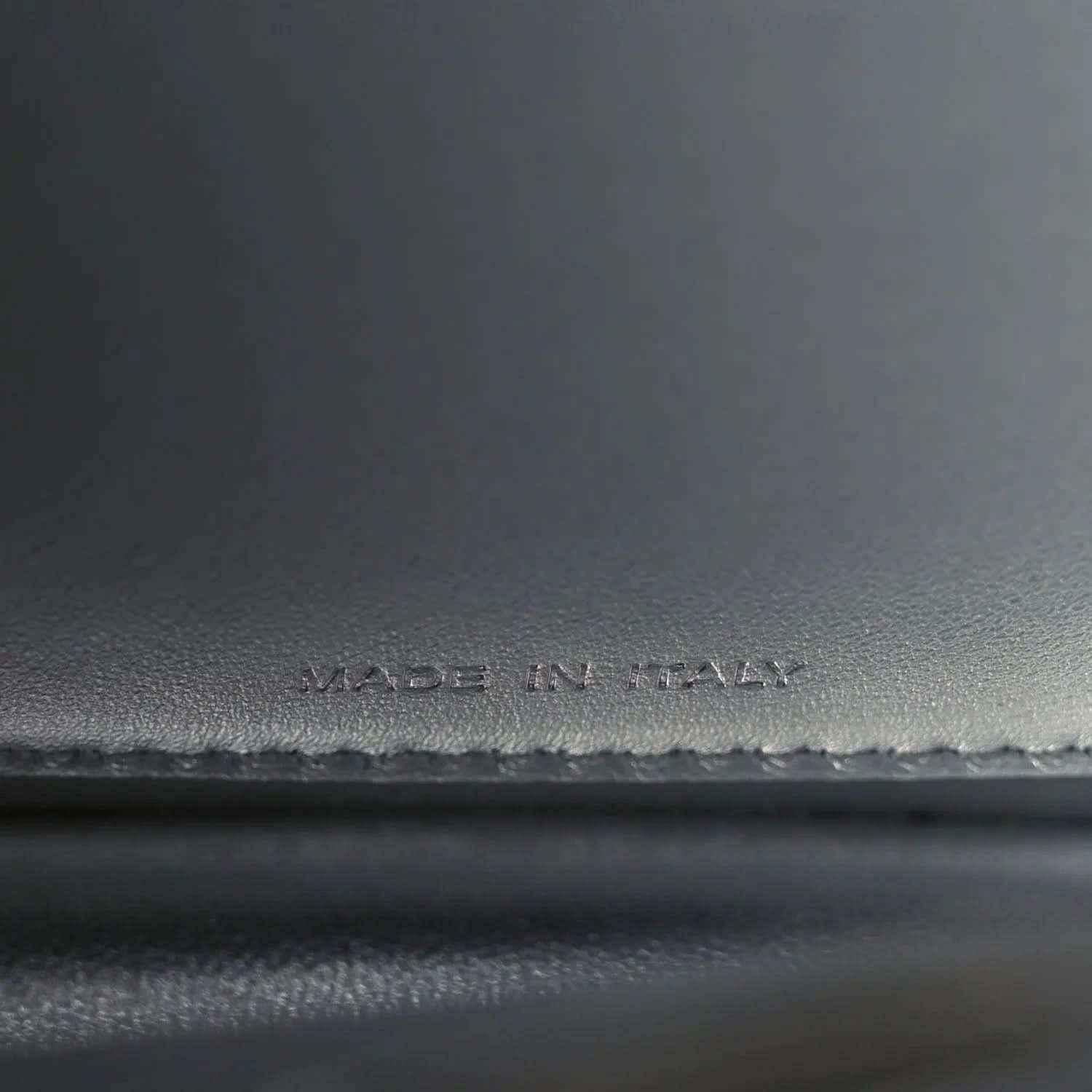 Made in Italy stamp on dark leather satchel interior