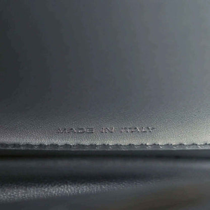 Made in Italy stamp on dark leather satchel interior