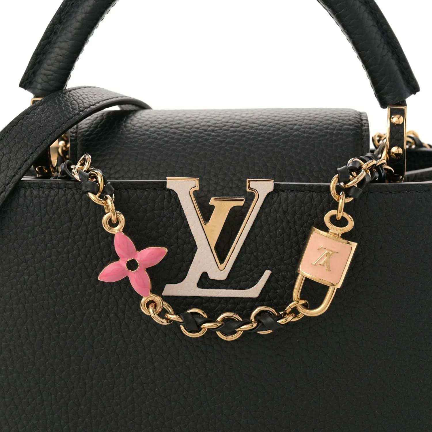 Black leather handbag front with gold LV logo, chain strap, and pink enamel flower charm