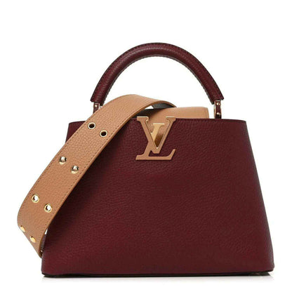 Bordeaux leather handbag with tan crossbody strap and gold Louis Vuitton logo.