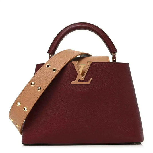 Bordeaux leather handbag with tan crossbody strap and gold Louis Vuitton logo.