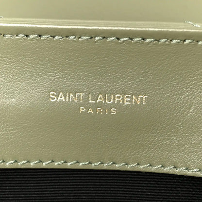 Light sage leather satchel interior wall with stitched trim and “SAINT LAURENT PARIS” text