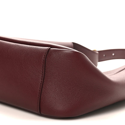 Burgundy leather hobo bag corner seam detail and top edge