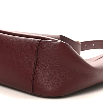 Burgundy leather hobo bag corner seam detail and top edge