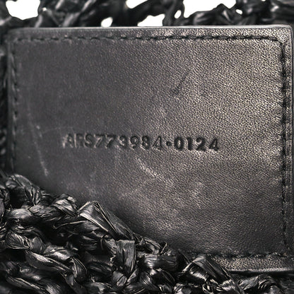 Black leather interior panel with embossed serial text on shoulder bag