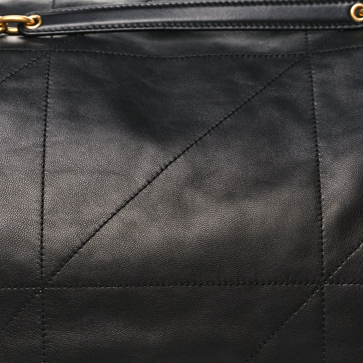 Black lambskin quilted matelasse panel with diagonal stitching and zipper trim