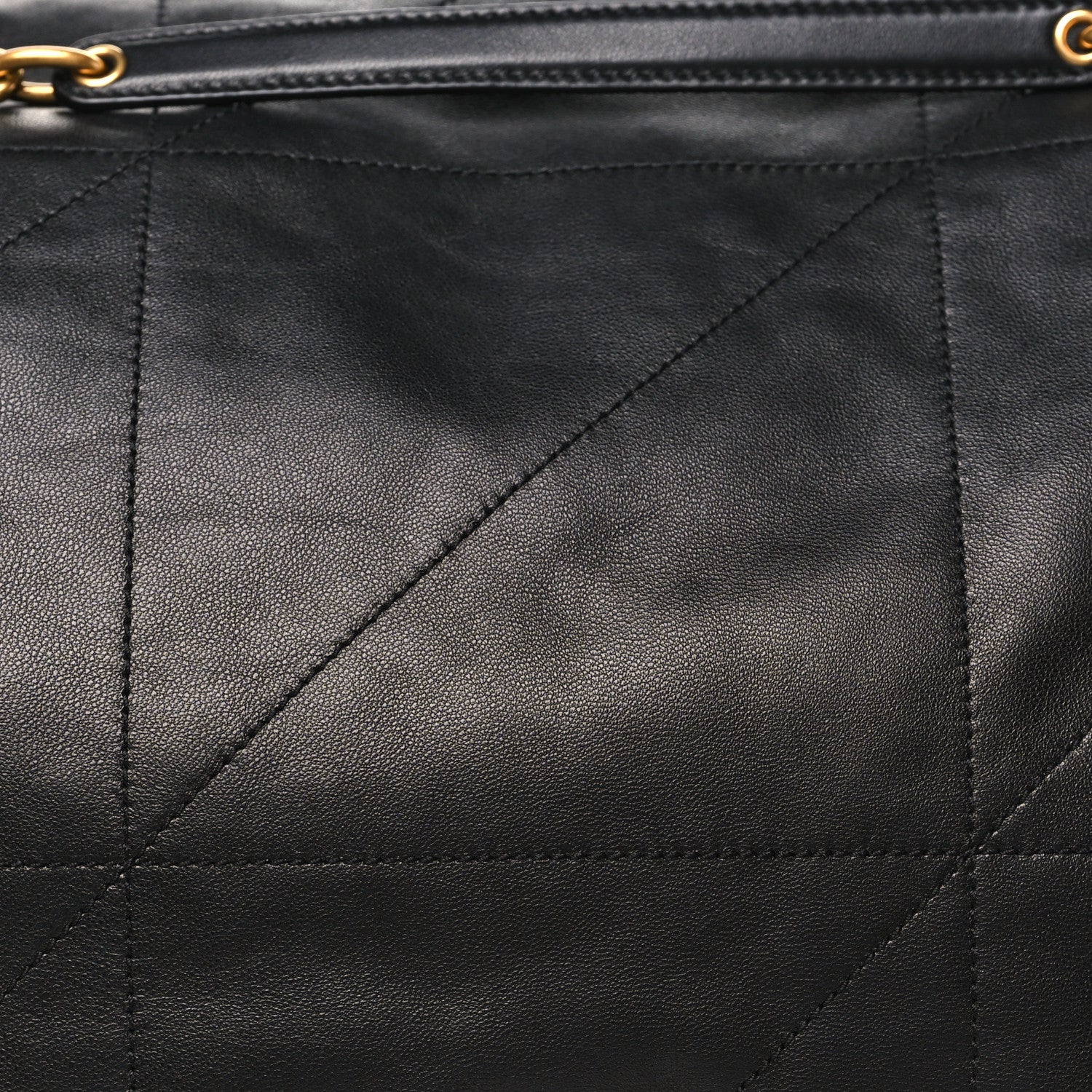 Black lambskin quilted matelasse panel with diagonal stitching and zipper trim