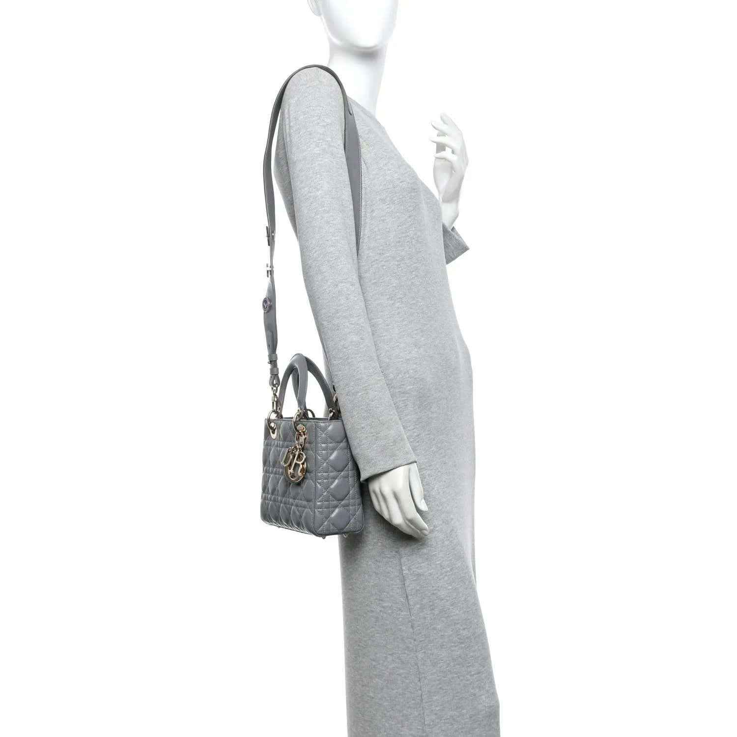 Grey quilted Lady Dior handbag worn crossbody with top handle and shoulder strap