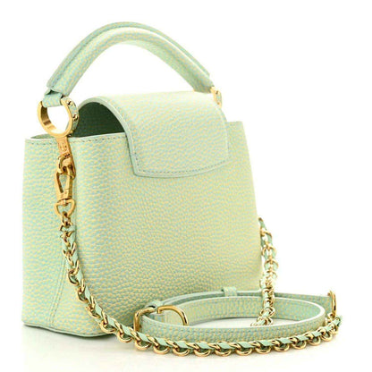 Mini Capucines handbag in light green textured leather with gold chain strap