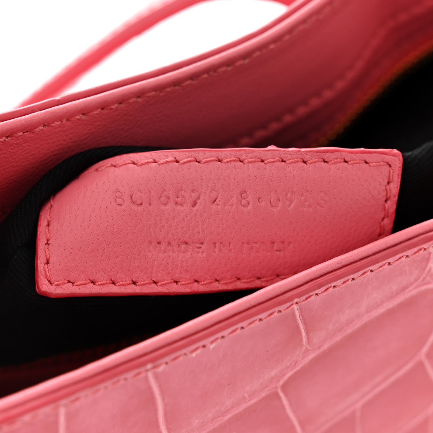 Pink alligator-textured hobo bag interior with “SAINT LAURENT” stitched leather patch