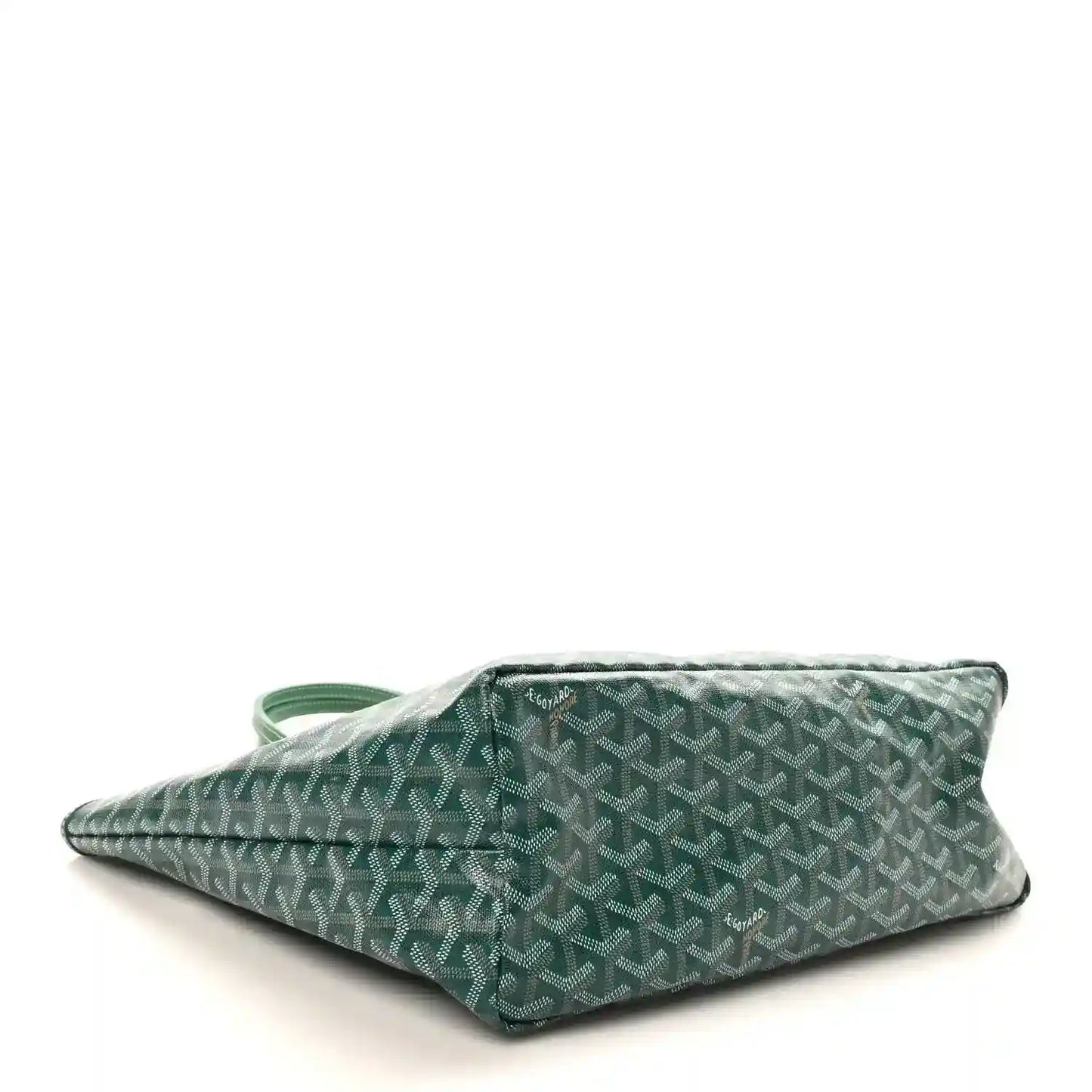 Green canvas tote bag laid flat, showing patterned body and side handle