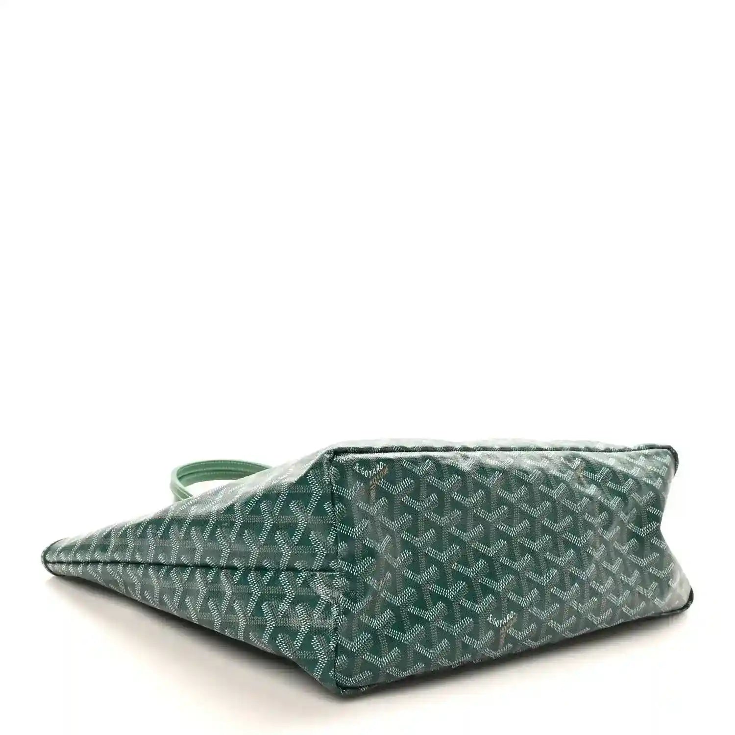 Green canvas tote bag laid flat, showing patterned body and side handle