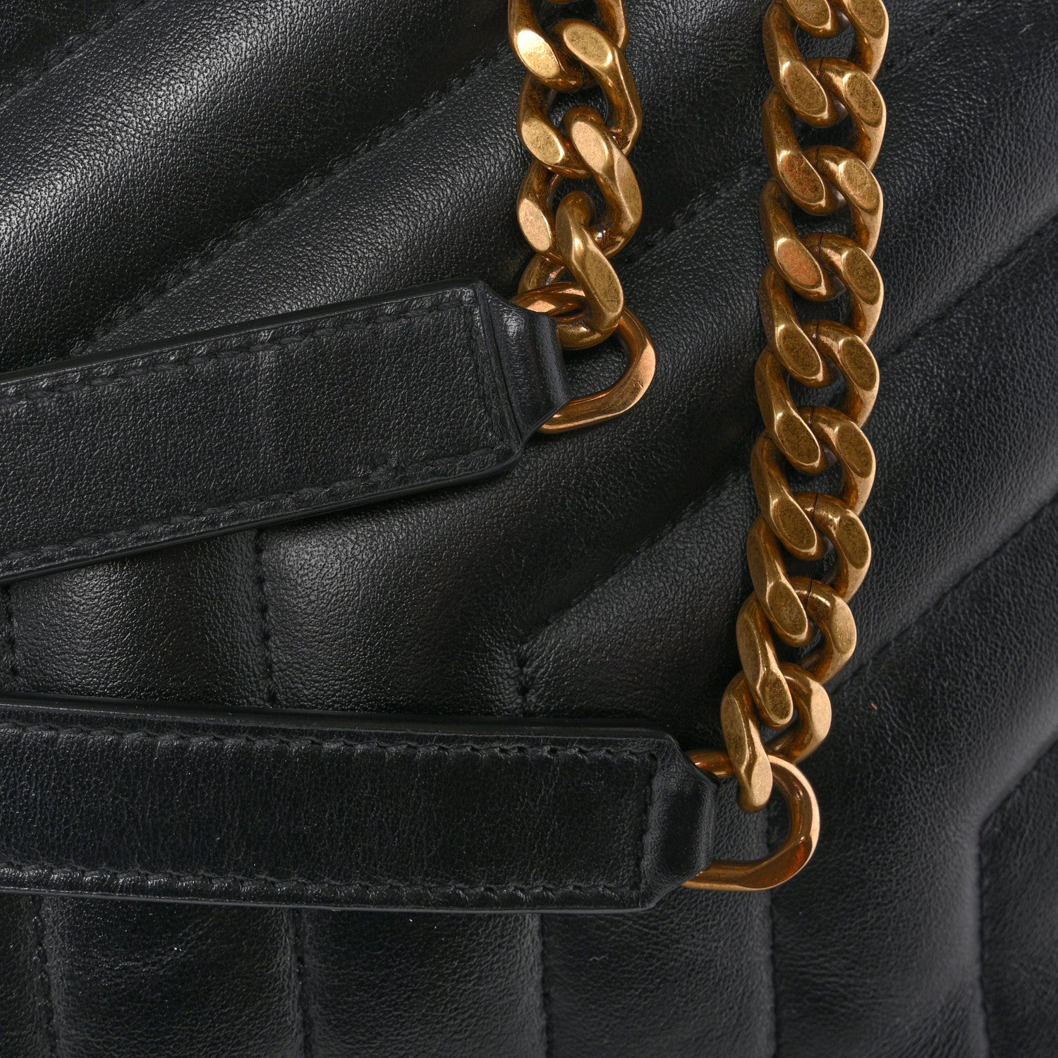 Black leather satchel with gold-tone chain strap and front tab
